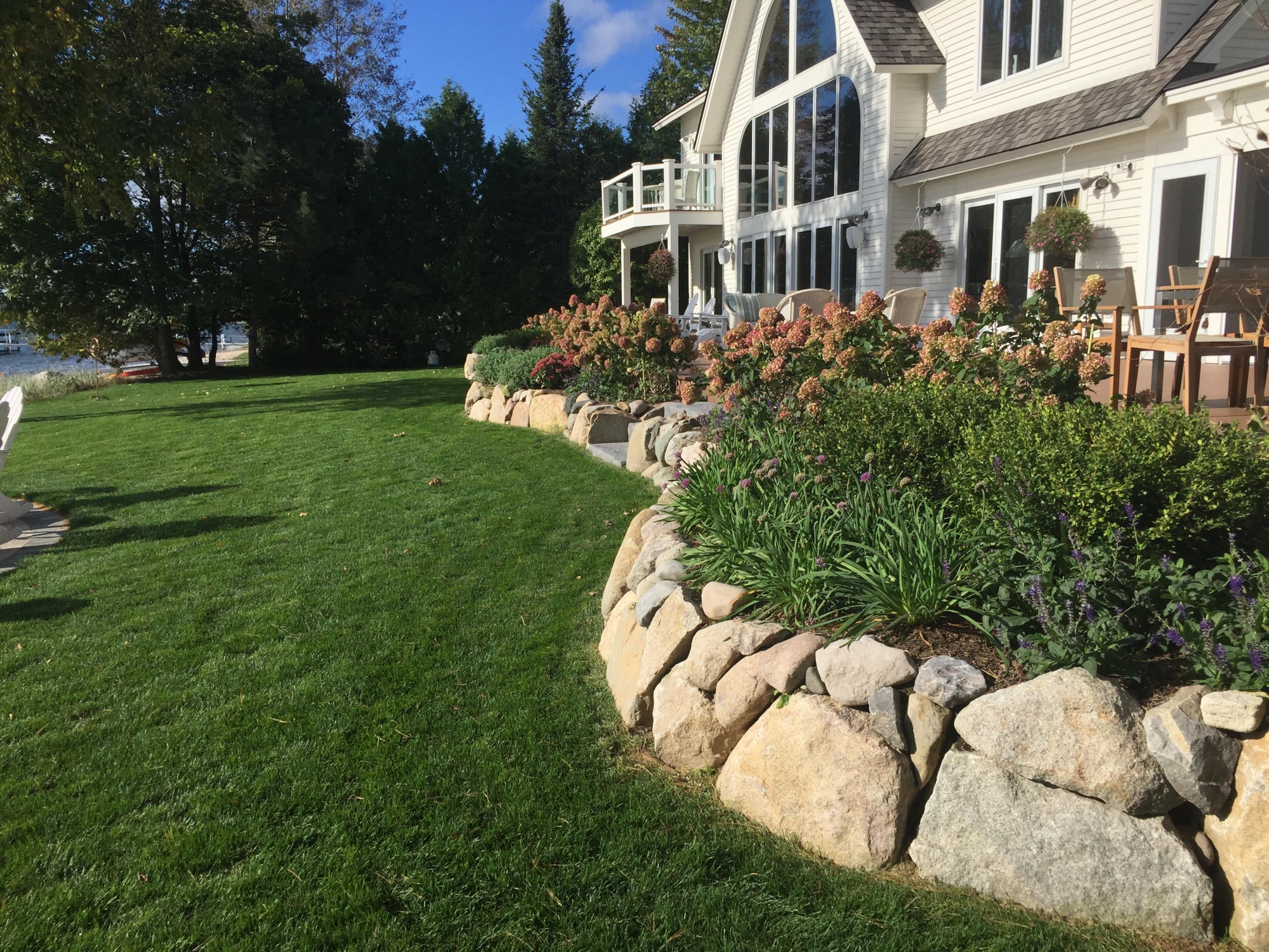 winding retaining wall against garden at Northern Michigan home