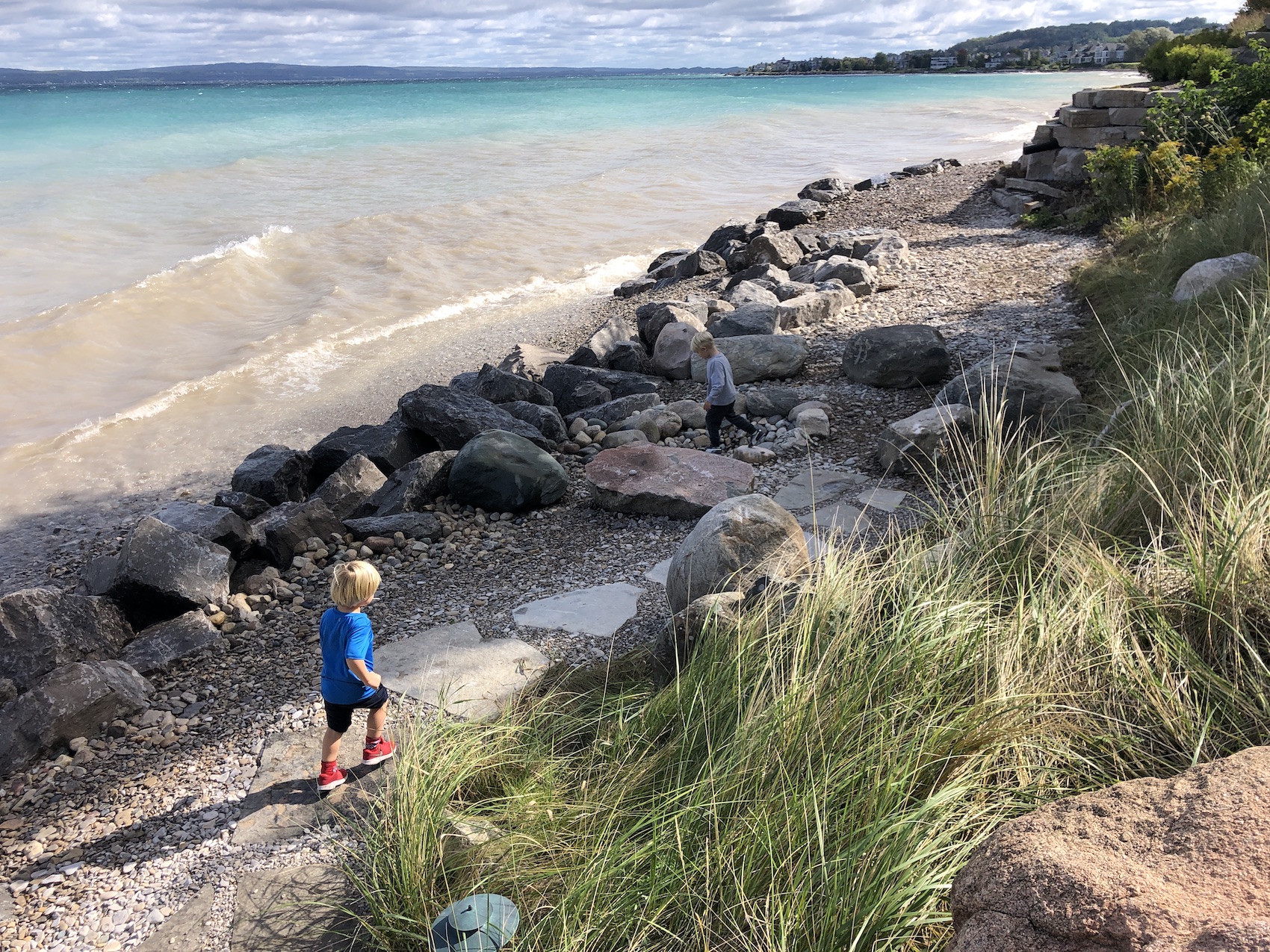 View of Lake Michigan with Child Running Along Natural Stone Path