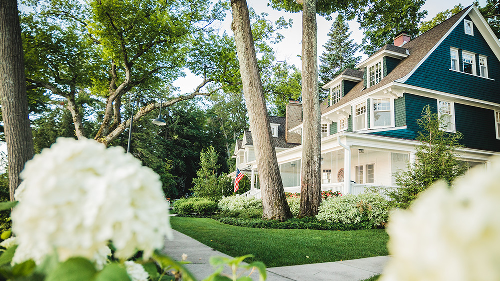 View of Green and White Harbor Point Home Through Hydrangeas