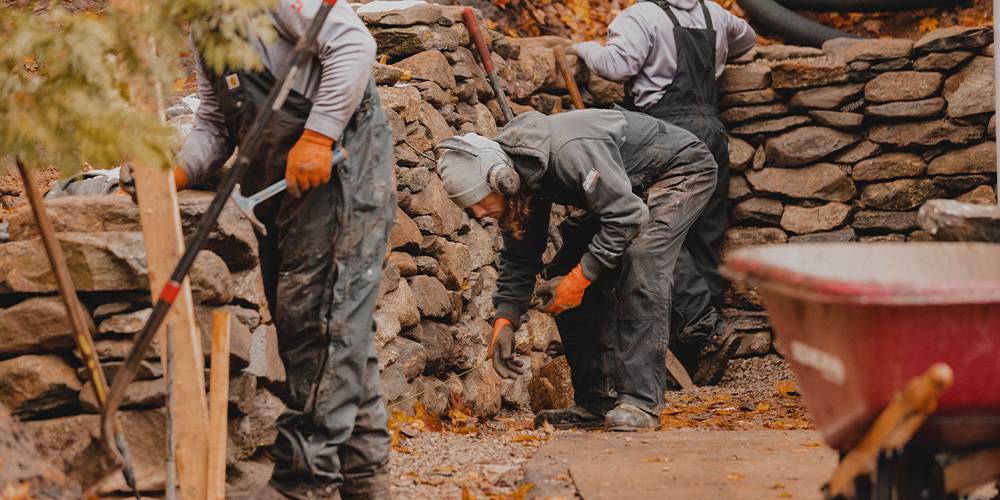 Vidosh North employees building retaining wall in Petoskey garden